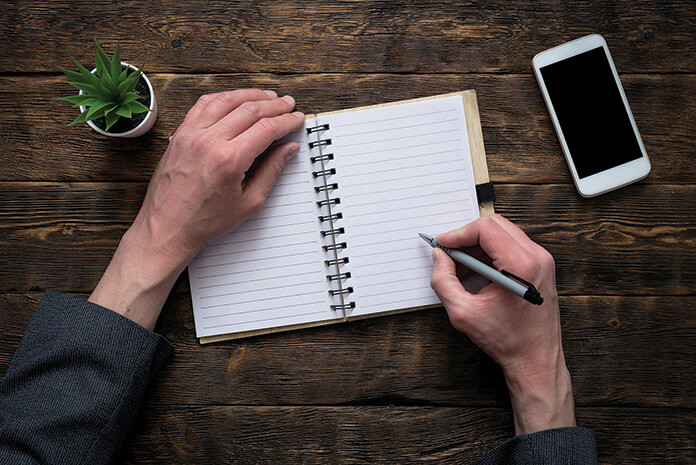 A man writing in a notebook