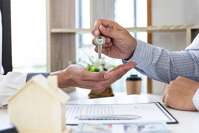 Handing over the keys to the new owners of a home